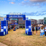 Photos from Day 1 of Outside Days 2026 at Auraria Campus in Denver featuring bands, festivalgoers, and outdoor installations.