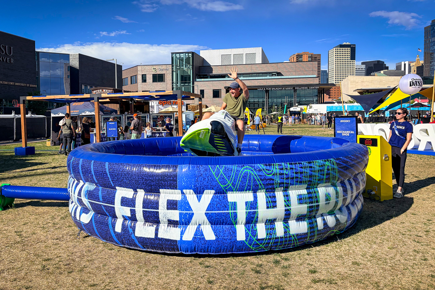 Festivalgoer rides a mechanical shoe installation at Outside Days 2026 in Denver.