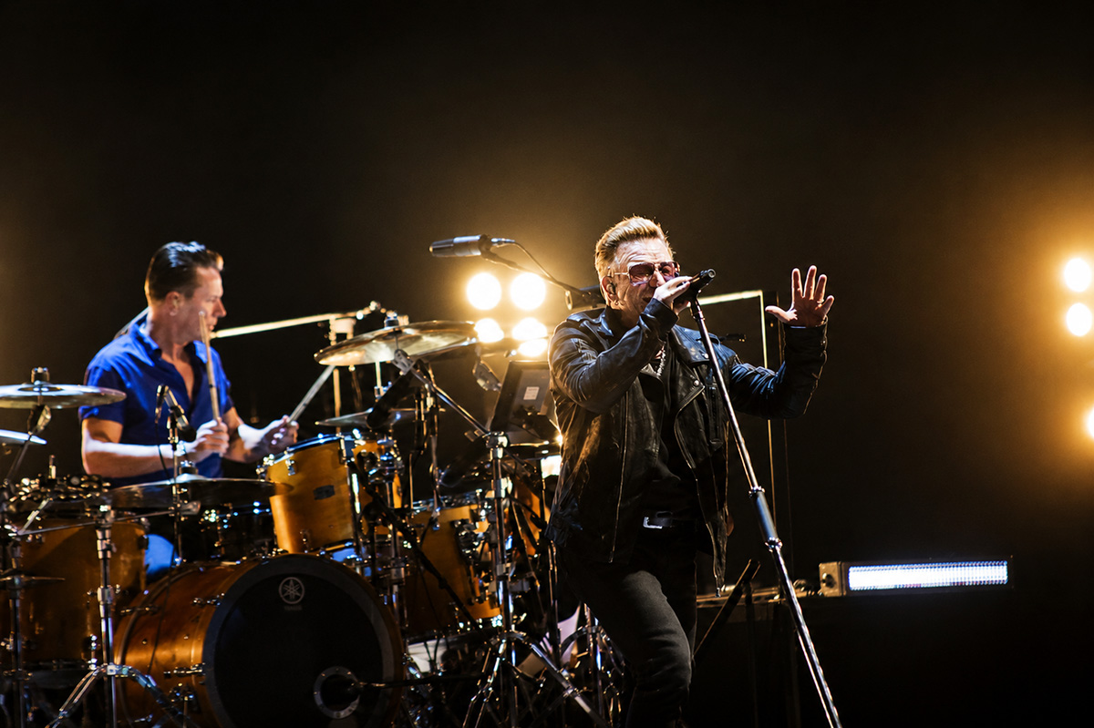 Bono performs with U2 in concert.